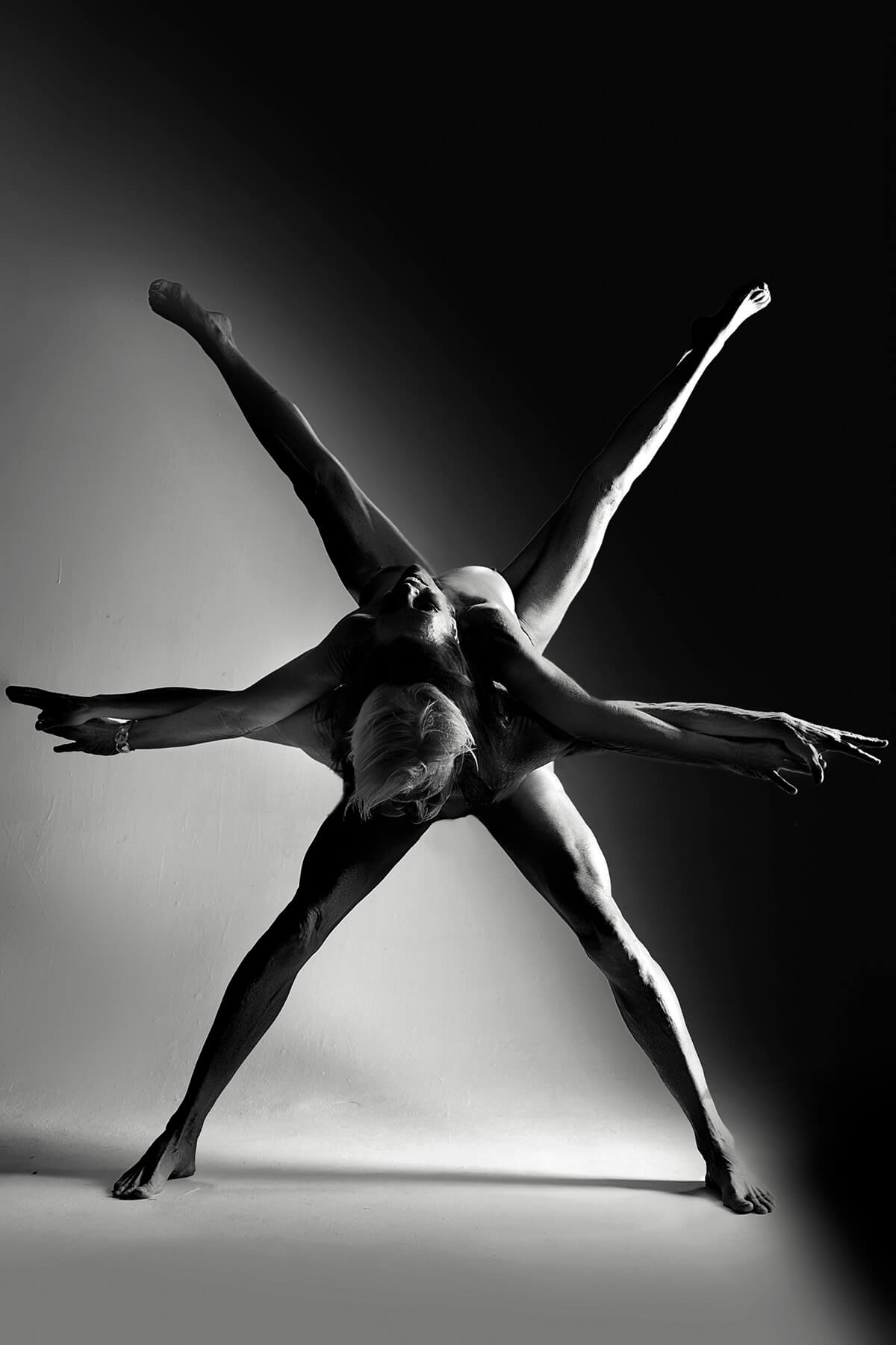 Astra — figure with limbs extended like a star constellation, fine art photograph by Alex Manfredini