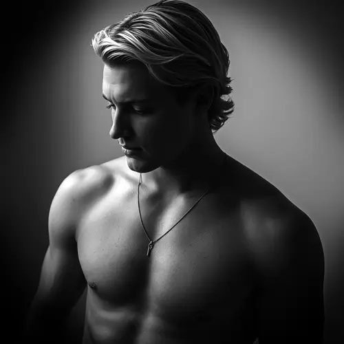 Male model under window light looking down
